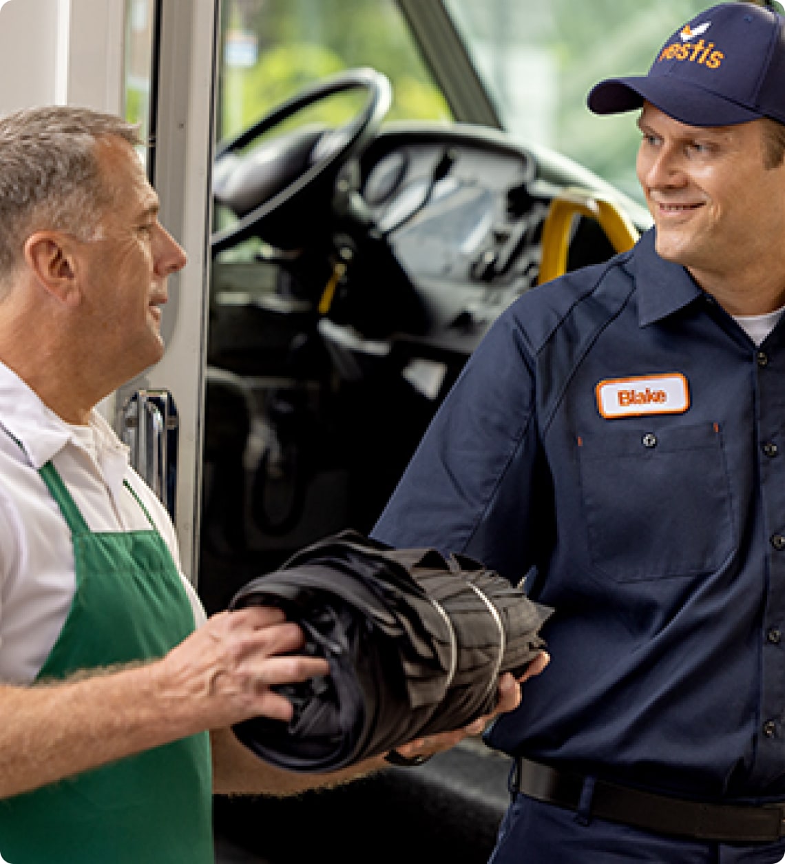 Two men smiling at each other