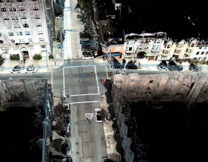 Aerial view of a city intersection with distorted buildings and streets.