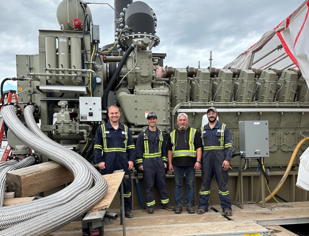 Group photo in front of generator