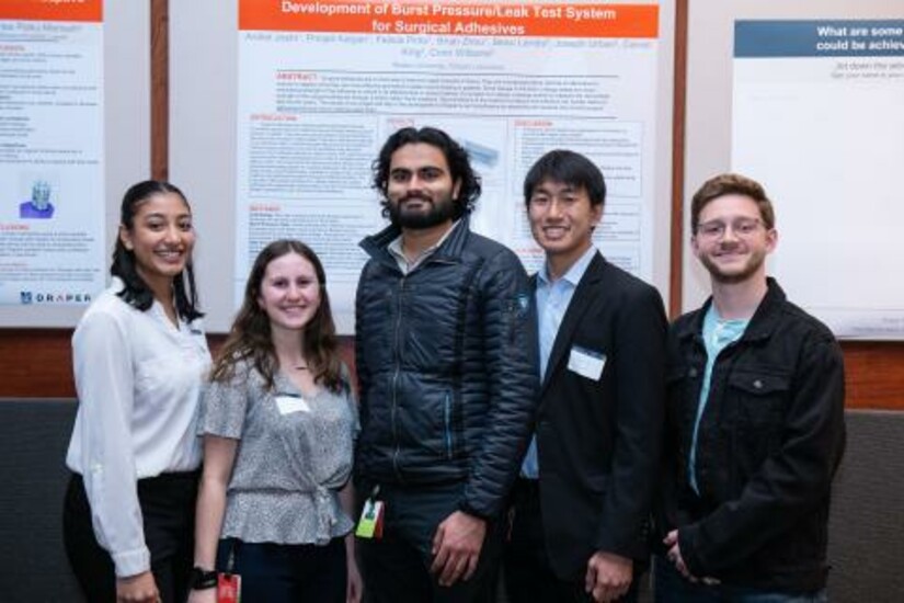 Boston University students present their surgical adhesive testing system at the Draper Research Symposium.