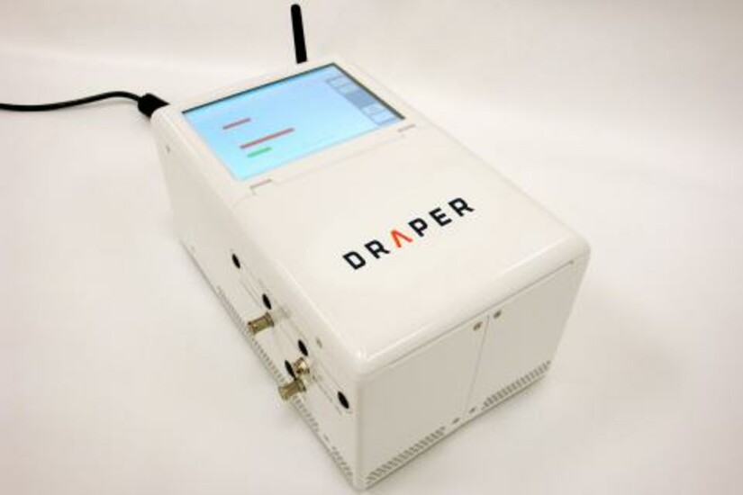 Draper’s microAnalyzer™ device, a white box with a screen and various input/outputs