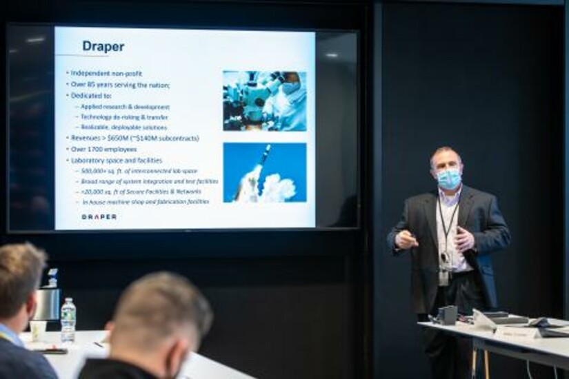Tony Kourepenis of Draper addresses U.S. Air Force officials on research and development updates.