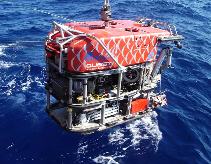 Underwater ROV "QUEST 4000 Meter" being deployed into the ocean for deep-sea exploration.
