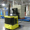 Automated forklift transporting stacked boxes in a modern warehouse.