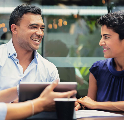 Smiling businessman talking with colleagues during meeting