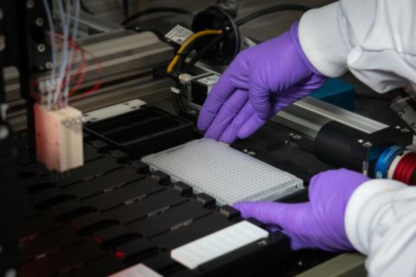 Setting up BioDot’s Rainmaker for DNA microarray printing to detect genetic signatures.