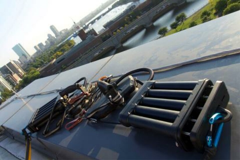 Z-Man climbing system equipment on a rooftop with a cityscape in the background.