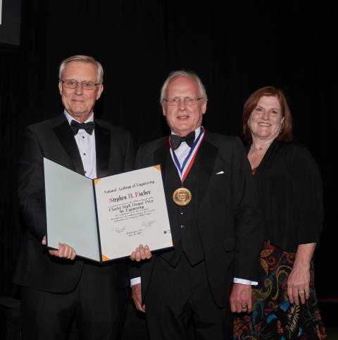 Stephen B. Furber is presented the 2022 Draper Prize by NAE President John L. Anderson and Draper Acting President and CEO Tara Clark. Credit: National Academy of Engineering.