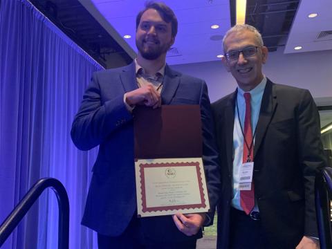 Daniel F. King, an engineer at Draper, earned top honors at the ASAIO conference for a presentation of the company’s pediatric heart valve. King (L) receives his award from ASAIO immediate past president Marvin Slepian, MD. Credit: American Society for Artificial Internal Organs (ASAIO).