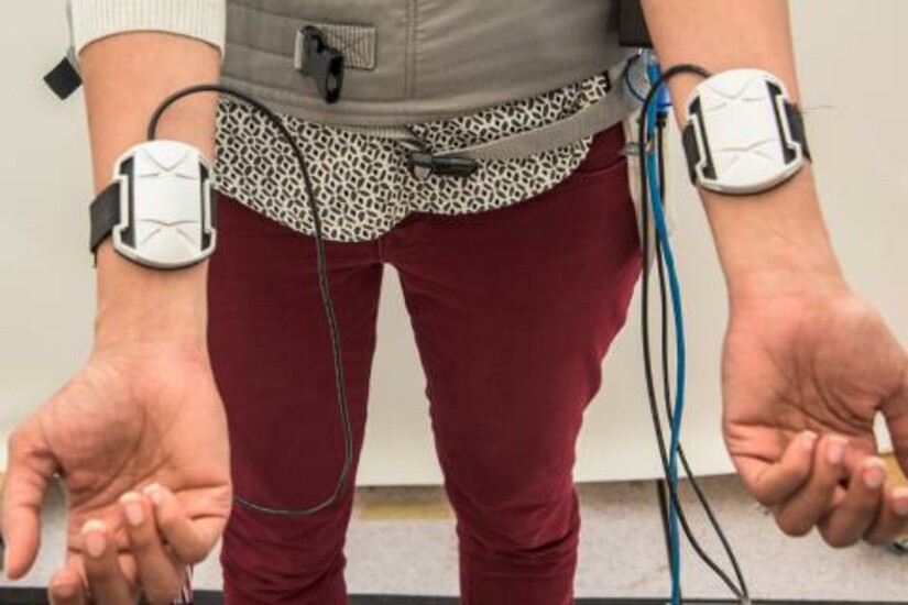 Person wearing a thermal device on their wrists 