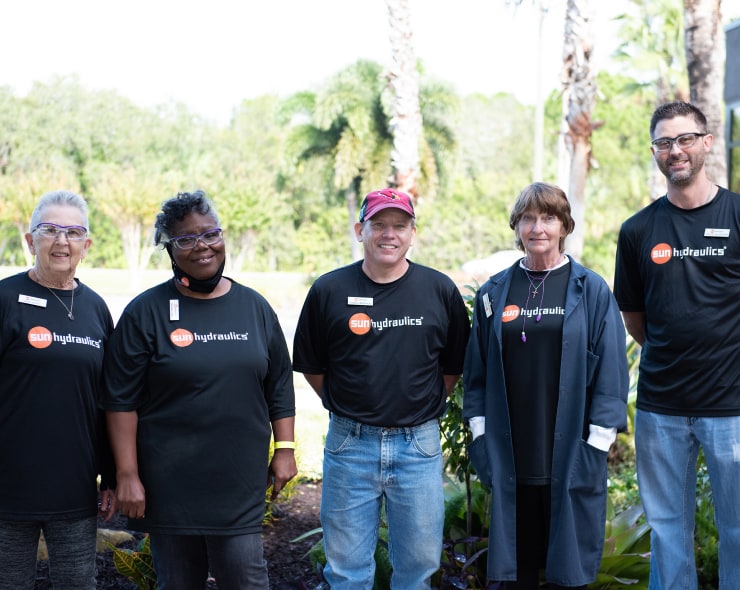 Employees posing for a group photo outdoors