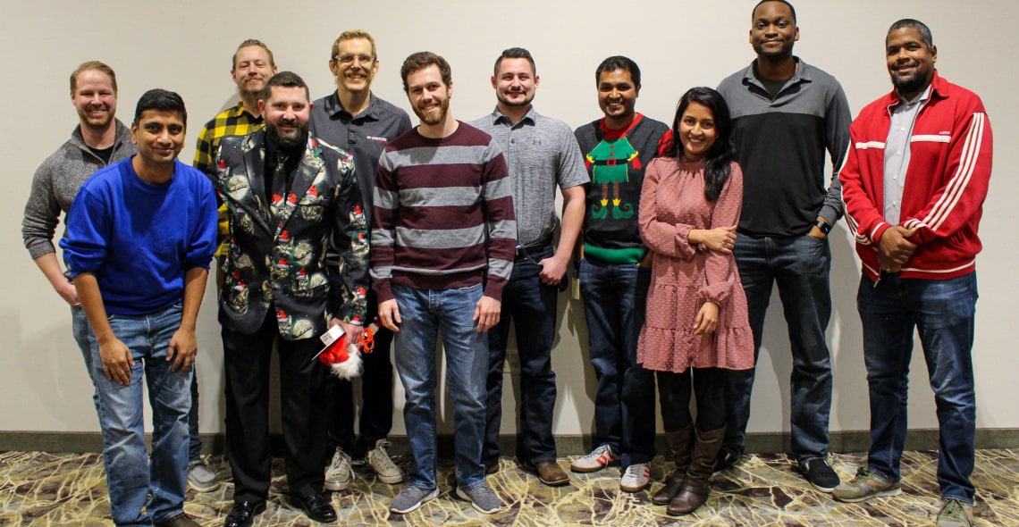 Employees posing for a group photo indoors