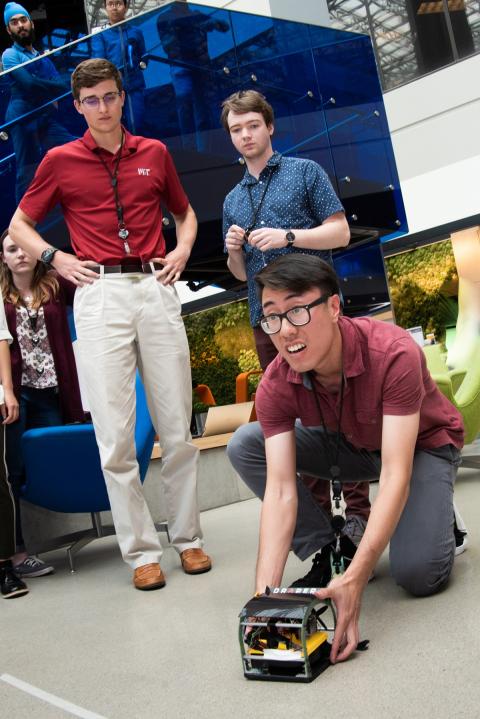 Members of Team Ductboat prepare their hovercraft to compete in Draper’s summer intern competition.