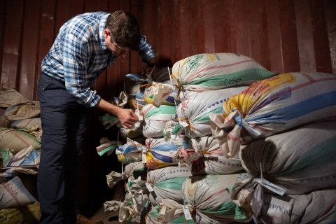 Adam Schafer, director of Supply Chain Sustainability at Intel, inspects bags of ore that have been sealed and tagged to confirm its provenance. A team from Intel's Responsible Minerals Program, as well as representatives of other tech firms, visited mineral-rich Rwanda in November 2019 as part of an industry effort to ensure a legal and ethical supply chain. Tin, tantalum, tungsten and gold mined in the Central African country are key components of silicon chips that run today's smartphones, laptops, servers and other high-tech gear. (Credit: Walden Kirsch/Intel Corporation)