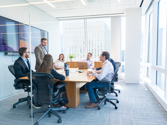 Teammates gathered in a meeting room in Barings headquarters office in Charlotte.