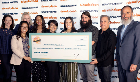 Skechers Foundation president Michael Greenberg (second from right) and executive director Robin Curren (third from left) present Skechers Pier to Pier Friendship Walk donations to the Friendship Foundation. Check recipients included executive director Rabbi Yossi Mintz (far right) and managing director Nina Patel (center). (Photo: Business Wire)