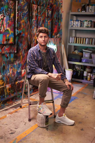 Artist James Goldcrown in studio with his iconic Love Wall heart designs that feature in the Skechers x JGoldcrown collaboration. (Photo: Business Wire)