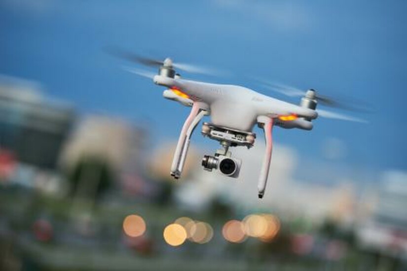 A drone in flight, showcasing Draper's lightweight electric motors for extended range.