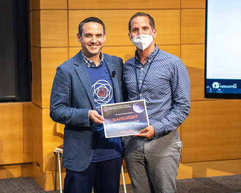 Dustin Martin of Draper congratulates Axel Garcia of SafeOrbit as a finalist at the COSMIC Pitch Competition during the Space Sector Market Conference. Credit: Draper.