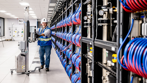 On June 22, 2023, Argonne National Laboratory, Intel and HPE announced that the installation progress of the Aurora Supercomputer is complete. In this photo, a member of the installation team brings in the last blade on a specialized trolley. (Credit: Argonne National Laboratory)