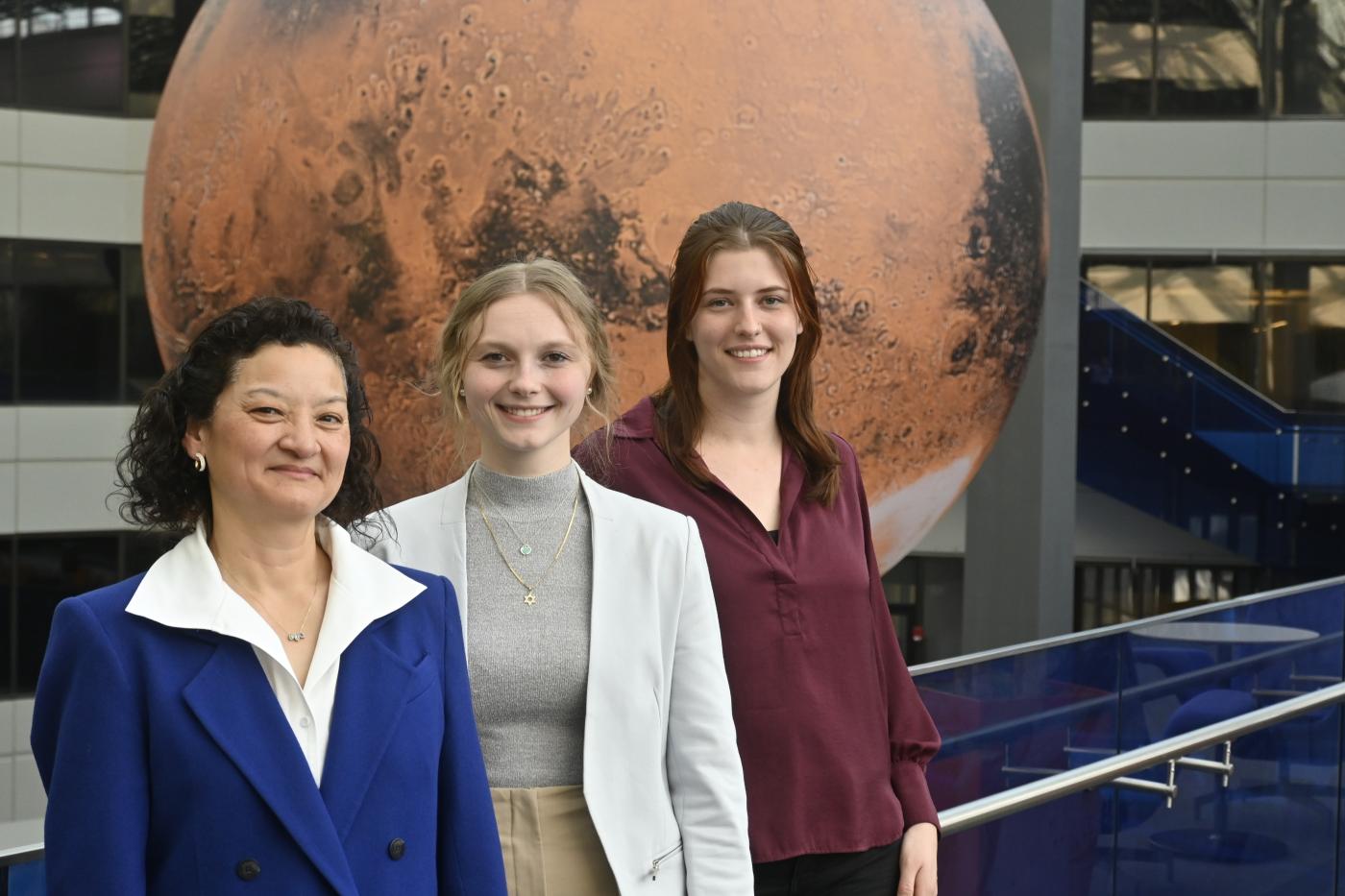 Kimberly Faunce, Shay Blechinger-Slocum and Hannah Goldstein pictured in front of a moon sculpture