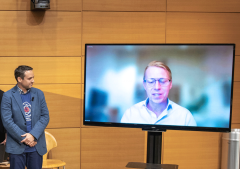 Dustin Martin of Draper congratulates John Jost of MicroR Systems as the winner of the COSMIC Pitch Competition during the Space Sector Market Conference. Credit: Draper