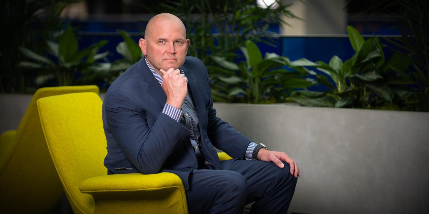 Jason Dupuis, Campus lead and senior program manager wearing a blue suit