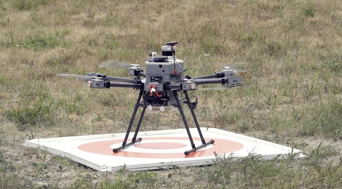 A drone on a landing pad with rotors In motion