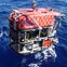 Underwater ROV "QUEST 4000 Meter" being deployed into the ocean for deep-sea exploration.