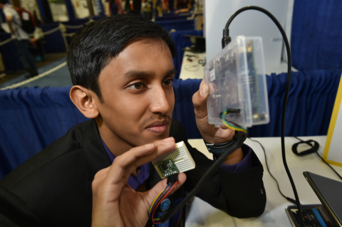 Amrit Sahu, 14, of India presents his 