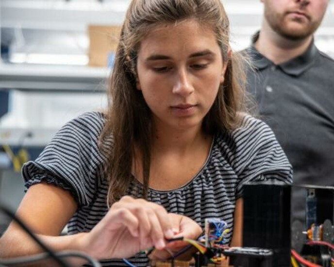 Engineering student works on equipment