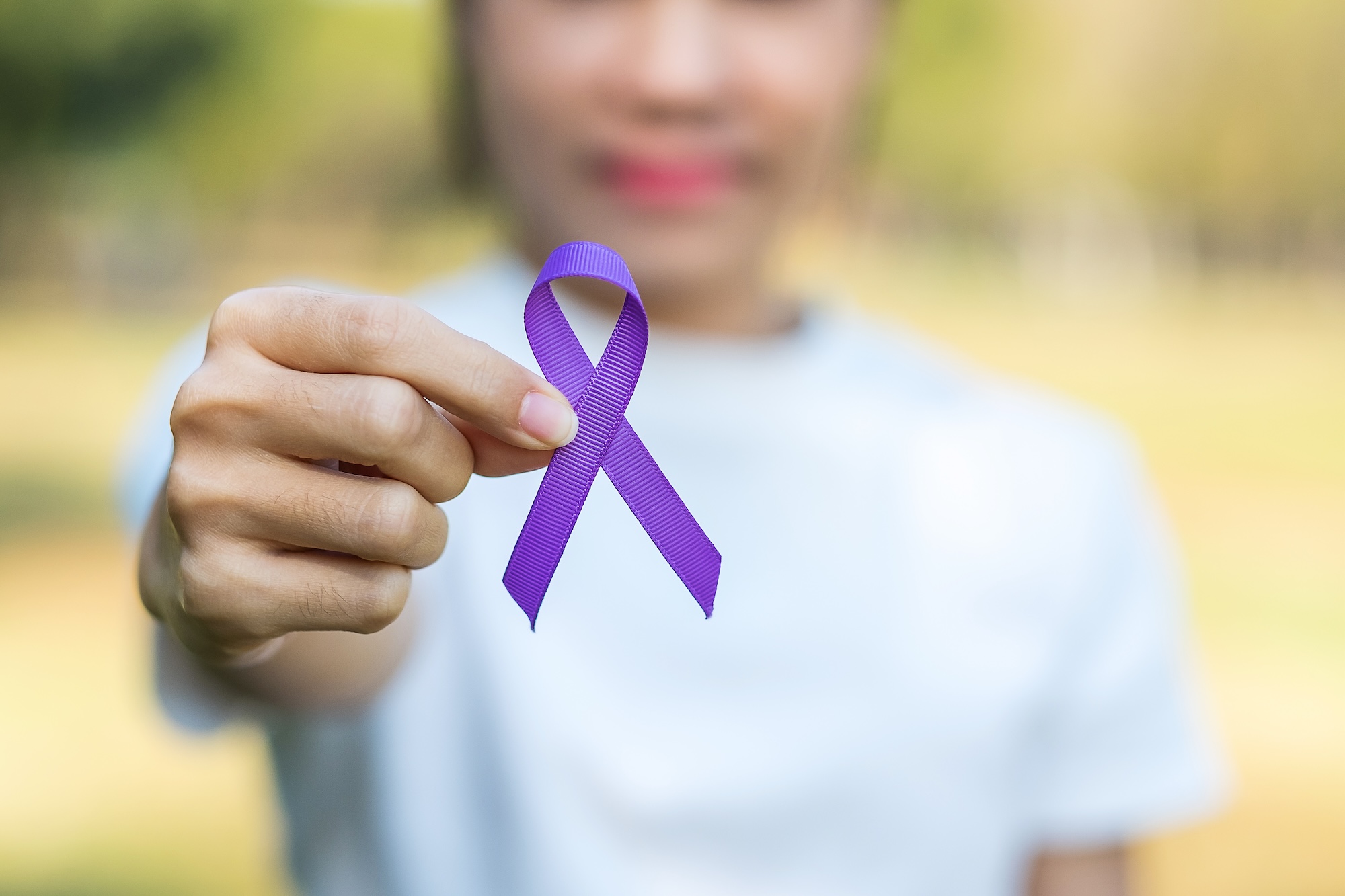 Women holding purple ribbon