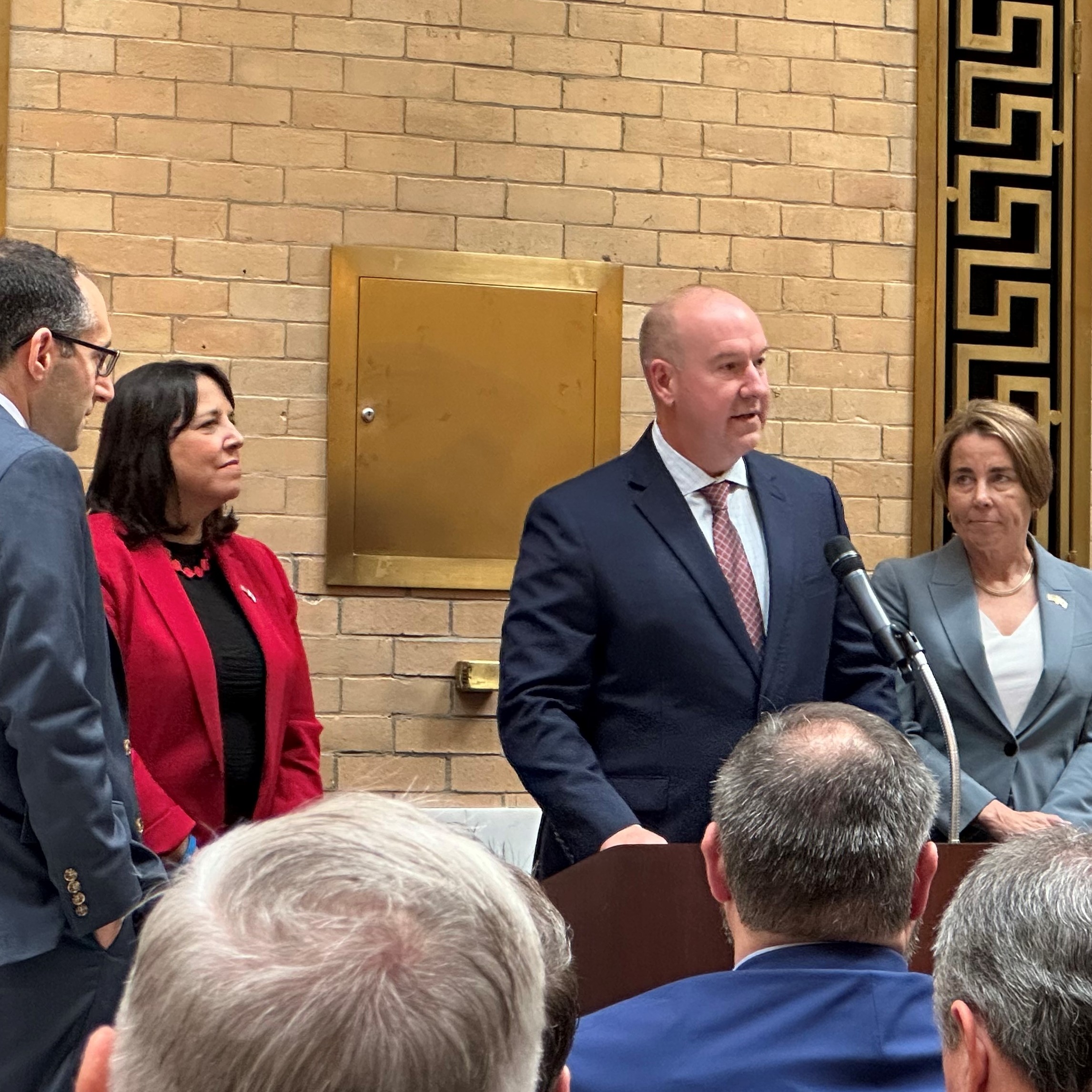 Photo of Draper President and CEO Jerry Wolhetz with Massachusetts Lt. Governor Kim Driscoll and Governor Maura Healey