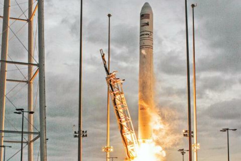 A rocket launches into the sky, leaving a trail of fire and smoke behind.