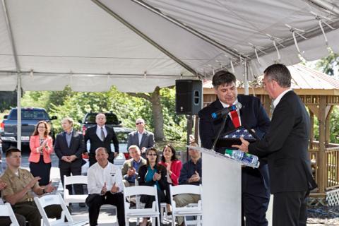 Rep. David Jolly presents Draper Rapid Prototyping Center lead William Ostrowski with a flag that had been flown over the U.S. Capitol.