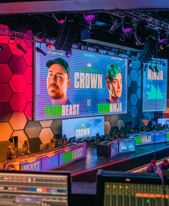 gaming stage, large LCD Screen displays two competitors