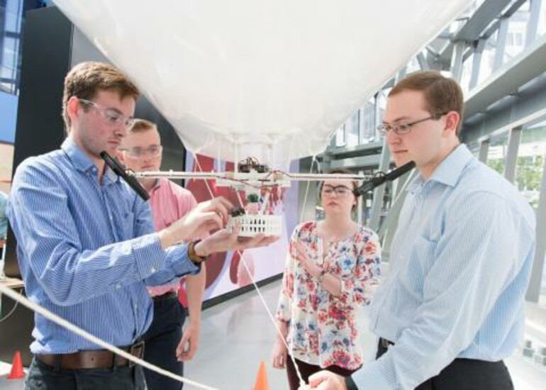 Engineering students work on a cellphone-guided blimp for a summer internship project.