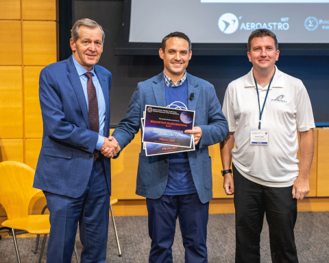 Dustin Martin of Draper congratulates Ironstar Engineering as a finalist at the COSMIC Pitch Competition during the Space Sector Market Conference. L-R are John Dargin III, of Ironstar; Martin; and Endri Lesha, also of Ironstar. Credit: Draper