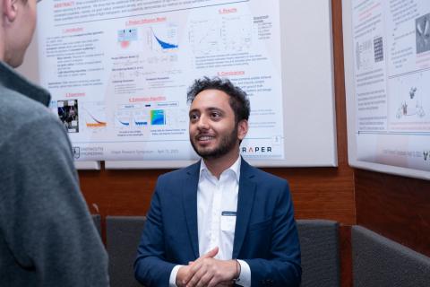Draper Scholar Yehia Helwa, a Master of Science degree candidate at the University of South Florida, presents research at the Draper Research Symposium. His research focused on a kind of dynamic vision sensor called an event camera, inspired by insect eyes, a potential benefit for helping drones move fast and reliably. Credit: Draper.