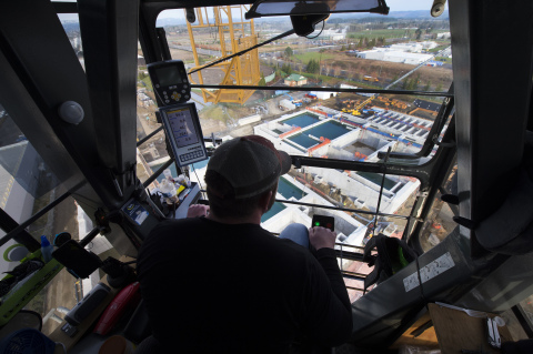 From inside his cab 150 feet above the Hillsboro, Oregon, job site, crane operator Darren Starks looks down on Intel’s under-construction water recycling plant. Starks can hoist skyward up to 40 tons at a time, and on a busy day is responsible for about 80 lifts of construction equipment, piping and other gear. When the recycling plant is completed, it will help Intel cut its manufacturing water use. Intel has set a goal to return 100 percent of its water to communities and watersheds for local use by 2025. (Credit: Walden Kirsch/Intel Corporation)