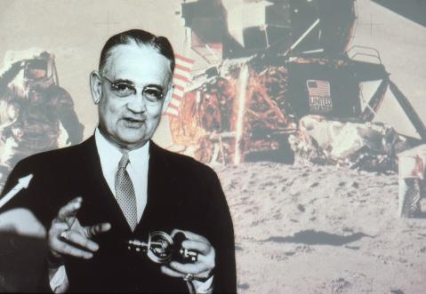 Charles Stark set against a background image of an astronaut and spaceship on the moon.