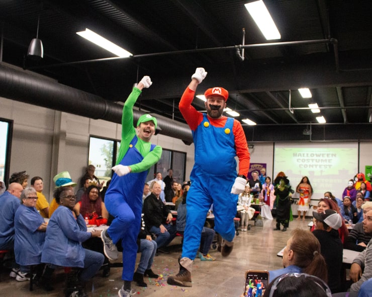 Two employees in costume as Mario and Luigi