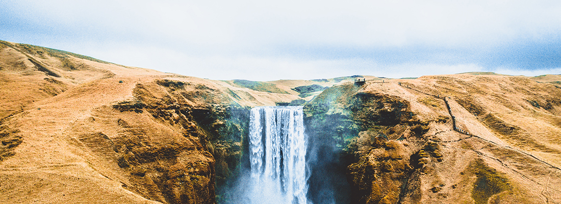 Waterfall cascading from an arid landscape.