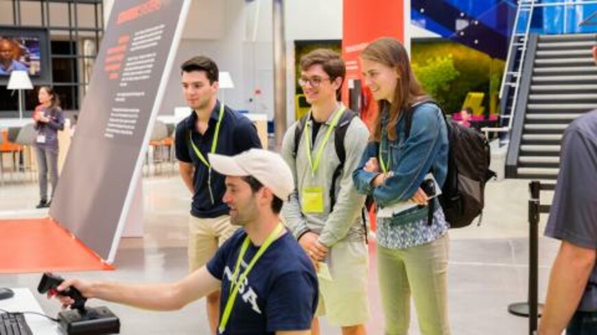 Visitors try their hand at navigating an automated signal control system in Draper's EP18 game.