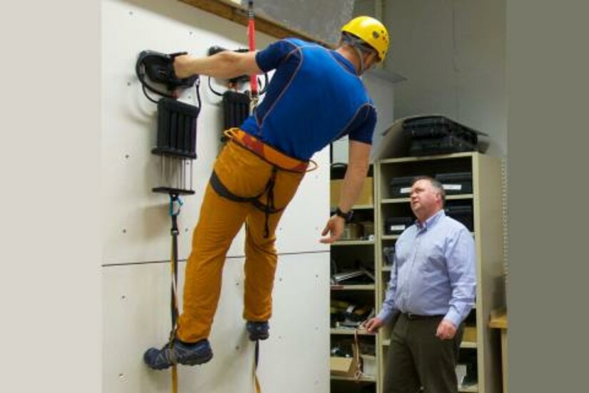 David Carter instructs Andy Torbet on using the Z-Man climbing system in a training session.