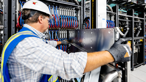 On June 22, 2023, Argonne National Laboratory, Intel and HPE announced that the installation progress of the Aurora Supercomputer is complete. In this photo, a member of the installation team places the last blade. (Credit: Argonne National Laboratory)