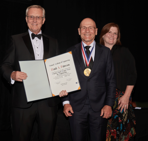 David A. Patterson is presented the 2022 Draper Prize by NAE President John L. Anderson and Draper Acting President and CEO Tara S. Clark. Credit: National Academy of Engineering.