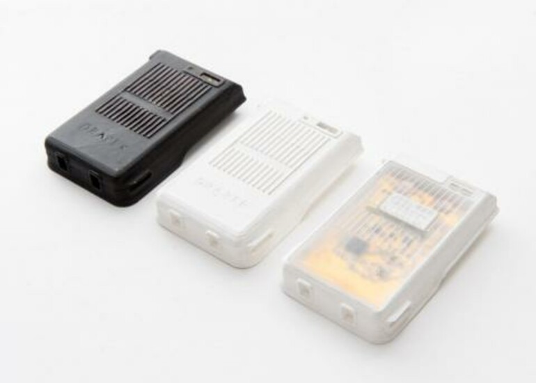 Three 3D-printed electronic device cases in black and white