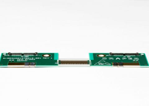 The elements of an edge-emitting light field projector module, composed of a flat PCB, flip-chip bonded SAW modulator and fiber-optic illuminator (not shown), are less than 2 mm thick.