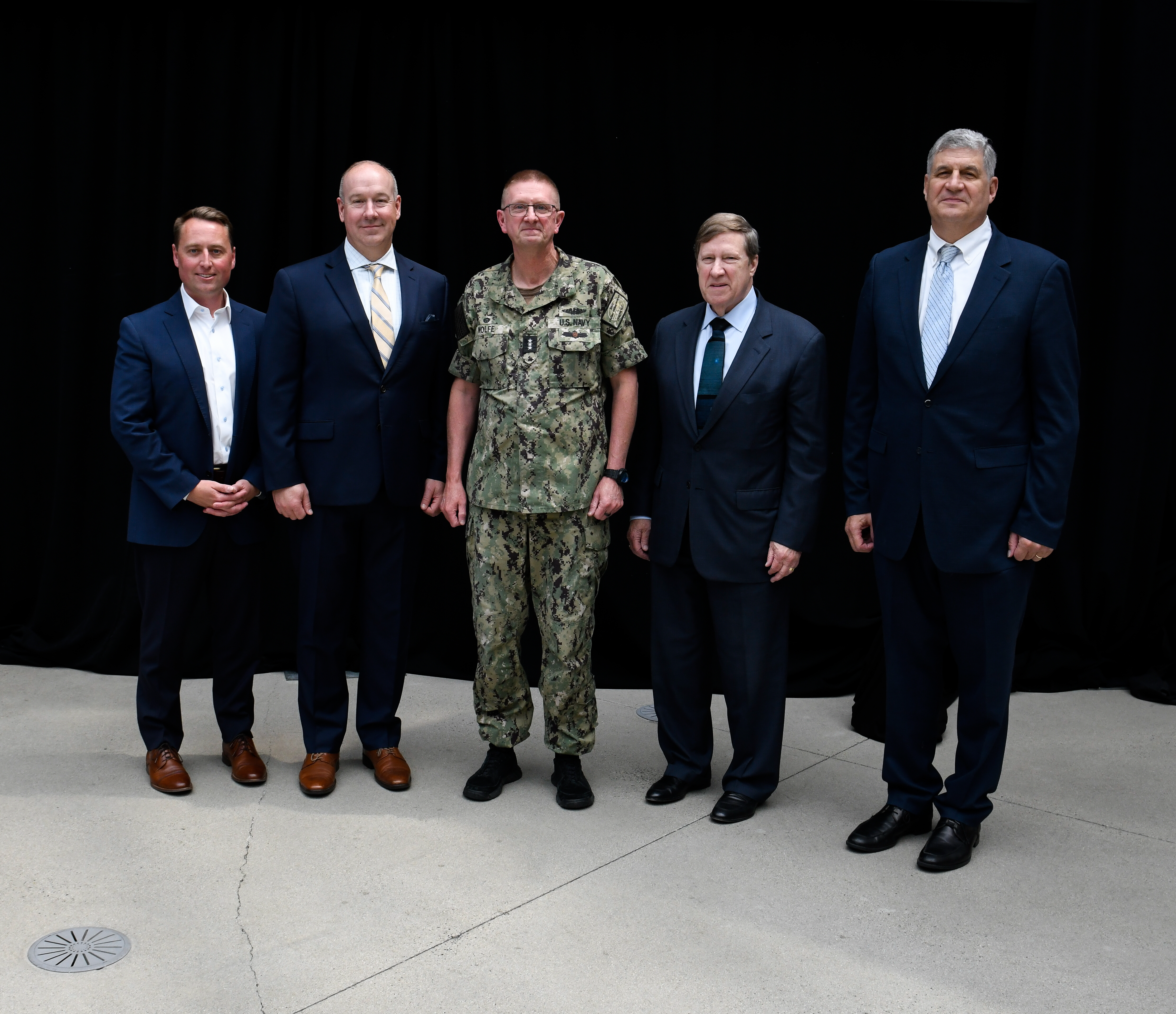 Photo of U.S. Navy Vice Admiral Johnny Wolfe, Jr. and members of Draper's senior staff.